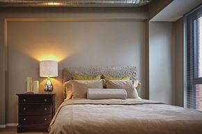 Chicago apartment for rent - A bedroom with a bed, nightstand, and lamp.