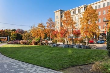 Wyandanch apartment for rent - A park with a grassy area and trees with autumn leaves.