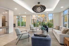 Wyandanch apartment for rent - A modern living room with a large window and a view of the outdoors.