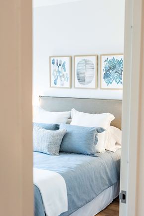 Wyandanch apartment for rent - A bed with a blue comforter and pillows is seen from the side.