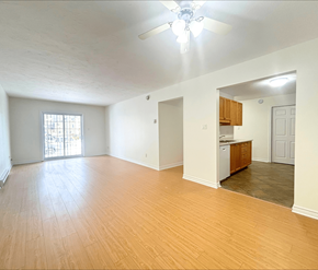 Moncton apartment for rent - A room with wooden floors and a ceiling fan.