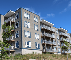 Fredericton apartment for rent - A modern apartment building with balconies and windows.