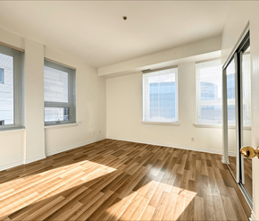 Moncton apartment for rent - A room with wooden flooring and white walls.