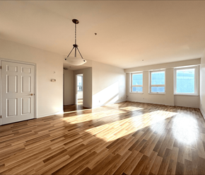 Moncton apartment for rent - A room with wooden floors and a white door.