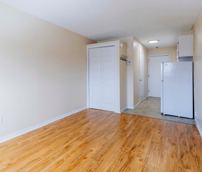Fredericton apartment for rent - A room with wooden floors and white walls.