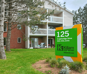 Halifax apartment for rent - A sign for Killam Apartment Rent in front of a building.