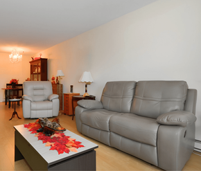 Halifax apartment for rent - A grey sofa sits in a living room with a coffee table in front of it.