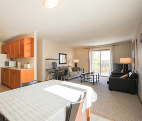 Fredericton apartment for rent - A bedroom with a bed, couch, and television.