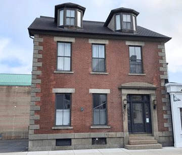 Halifax apartment for rent - A red brick building with a black door and windows.