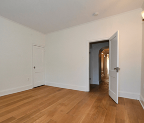 Halifax apartment for rent - A room with a wooden floor and white walls.