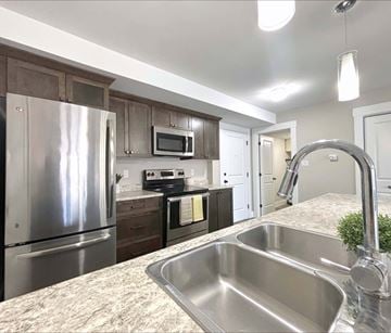 Dieppe apartment for rent - A kitchen with a stainless steel sink and refrigerator.