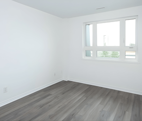 Ottawa apartment for rent - A room with a window and wooden flooring.