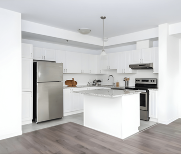 Ottawa apartment for rent - A modern kitchen with a stainless steel refrigerator and a white island.