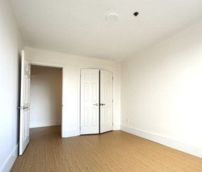 Halifax apartment for rent - A room with white walls and wooden flooring with two white doors.