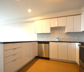 Halifax apartment for rent - A kitchen with white cabinets and a black countertop.
