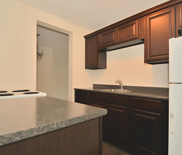 Halifax apartment for rent - A kitchen with brown cabinets and a white refrigerator.