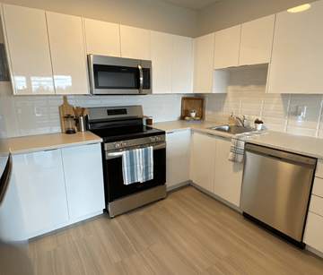 Halifax apartment for rent - A modern kitchen with white cabinets and stainless steel appliances.