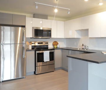 Halifax apartment for rent - A modern kitchen with a stainless steel refrigerator and a microwave above the stove.