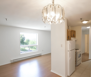 Halifax apartment for rent - A white kitchen with a large window and a chandelier.