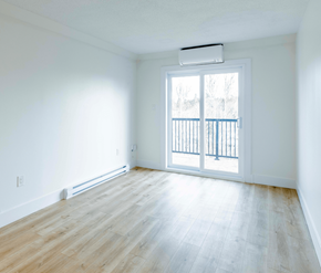 Fredericton apartment for rent - A room with a window and a balcony.