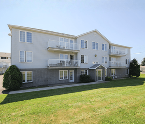 Dieppe apartment for rent - A large two-story apartment building with a balcony on the second floor.