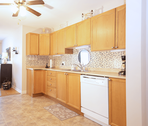Fredericton apartment for rent - A kitchen with wooden cabinets and a white dishwasher.