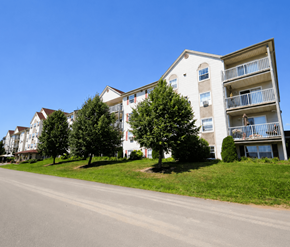 Dieppe apartment for rent - Apartment building with a tree in front of it.