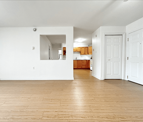 Dieppe apartment for rent - A room with wooden floors and white walls.