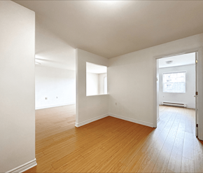 Dieppe apartment for rent - Empty room with wooden floors and white walls.