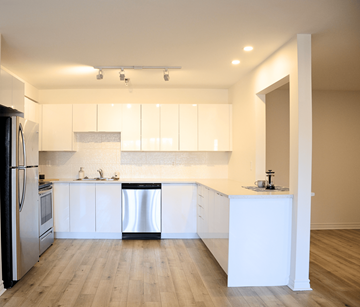 Halifax apartment for rent - A kitchen with white cabinets and a wooden floor.
