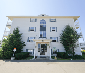 Dieppe apartment for rent - A two-story building with a white facade and a covered entrance.