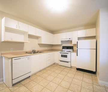 Dieppe apartment for rent - A kitchen with white appliances and cabinets.