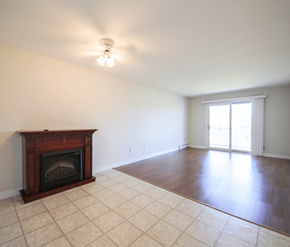 Dieppe apartment for rent - A room with a fireplace and tile flooring.