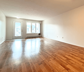 Dieppe apartment for rent - A room with wooden flooring and two doors.