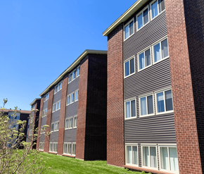 St. John's apartment for rent - A building with a grey facade and a brick chimney.