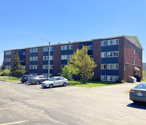 St. John's apartment for rent - A parking lot with cars and a building in the background.