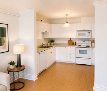 St. Johns apartment for rent - A well-lit kitchen with white cabinets and wooden flooring.