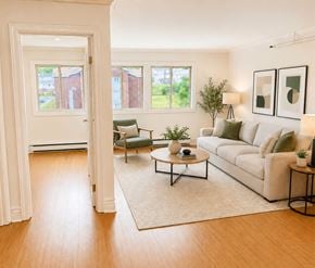 St. Johns apartment for rent - A living room with a white couch, a green chair, and a coffee table.