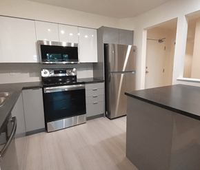 Halifax apartment for rent - A modern kitchen with stainless steel appliances and white cabinets.