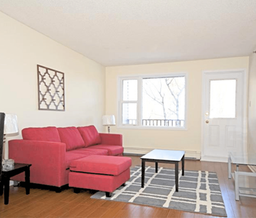 Halifax apartment for rent - A red couch in a living room with a small table in front of it.