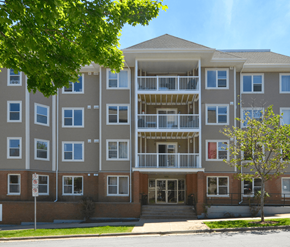 Halifax apartment for rent - A large apartment building with a tree in front.