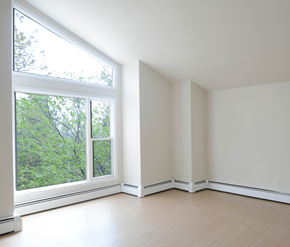 Halifax apartment for rent - A room with a window overlooking a tree-filled area.