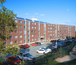Halifax apartment for rent - A parking lot in front of a red brick building.