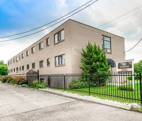 London apartment for rent - A building with the number 1447 on it is surrounded by a black fence.