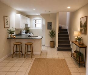 Halifax apartment for rent - A kitchen with white cabinets and a countertop with two bar stools.