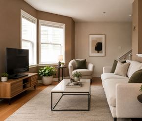 Halifax apartment for rent - A living room with a white couch, a coffee table, and a television.