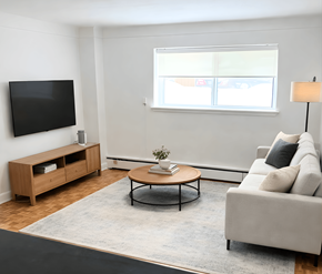 Ottawa apartment for rent - A living room with a grey couch, a wooden coffee table, a television, and a window with blinds.