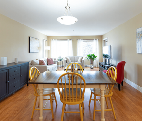 Moncton apartment for rent - A dining room with a wooden table and chairs.