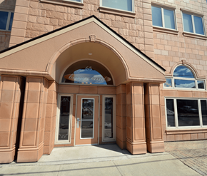 Moncton apartment for rent - A building with a brown facade and a large arched entrance.