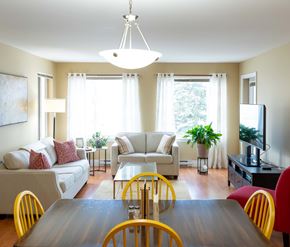 Moncton apartment for rent - A well-lit living room with a dining table and chairs.